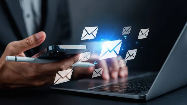 Businessman sending email by laptop computer to customer, business contact and communication, email icon, email marketing concept, send e-mail or newsletter, online working internet network.