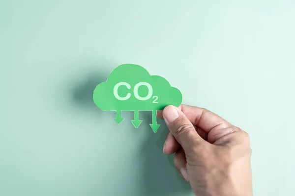 Hand holding Global earth decrease CO2 or carbon dioxide emission, carbon footprint and carbon credit to limit global from climate change, Earth for develop green energy.