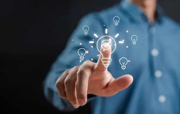 Hand man holding illuminated lightbulb, idea, innovation and inspiration, smart business intelligent creativity with bulbs, Motivation and innovation concept.