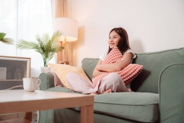 Asyalı Kadın Oturma Odası 'nda Televizyon İzleme Rahatlığı Genç Eğlence Evi, Neşeli Evinde En Sevdiği Şovu Seviyor, Sevinçle Kucaklaşma, Rahatlık ve Konforlu Bir Daire Ayarlama