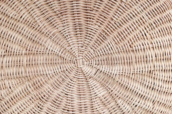 Circular weave rattan pattern, round rattan furniture background light brown texture, weave rattan texture and background. a fragment of a basket made of willow twigs or garden furniture, texture