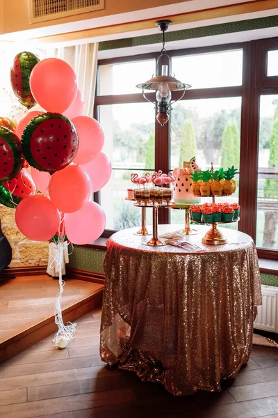birthday exitic catering, table with modern desserts, cupcakes, sweets with flamingo. delicious candy bar at expensive birthday party. space for text. baby shower. holiday celebration.