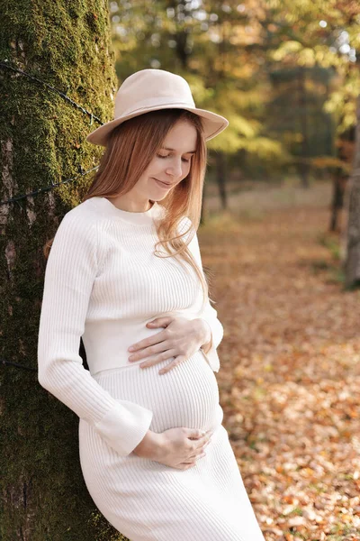Elegant Young Pregnant Woman White Knit Dress Hat Touching Stroking — Fotografie, imagine de stoc