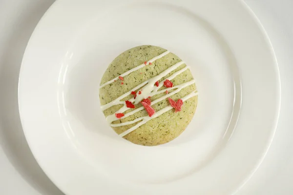 stock image Homemade mint gingerbread cookie with matcha and decorated sublimated strawberries and vanilla cream on white plate isolated on white background. Sugar, gluten and lactose free and vegan