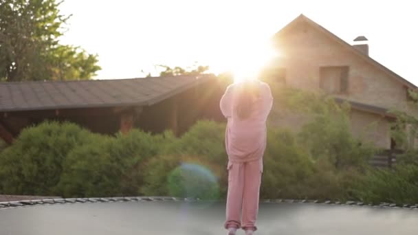 Happy Little Child Girl Having Fun Jumps Trampoline Outdoors Backyard — Stock Video