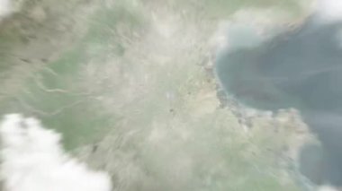 Dünya uzaydan Cangzhou 'ya, Nanhu Park' taki Çin 'e yakınlaşır. Arkasından bulutlar ve atmosferden uzaya zum geliyor. Uydu görüntüsü. Seyahat girişi