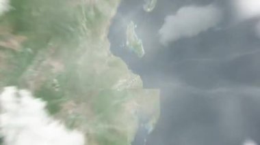 Dünya uzaydan Dar es Salaam, Tanzanya 'ya yakınlaşır. Arkasından bulutlar ve atmosferden uzaya zum geliyor. Uydu görüntüsü. Seyahat girişi