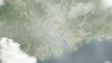 Dünya, uzaydan Guangzhou, Çin 'e yakınlaşır. Arkasından bulutlar ve atmosferden uzaya zum geliyor. Uydu görüntüsü. Seyahat girişi