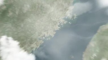 Dünya, Çin 'deki Quanzhou, Belediye Hükümeti' ne uzaydan yakınlaşır. Arkasından bulutlar ve atmosferden uzaya zum geliyor. Uydu görüntüsü. Seyahat girişi