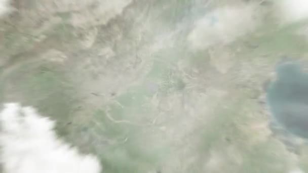 宇宙からバウディング ジュニアオ記念ホールに地球がズームします 雲と大気を通して宇宙にズームアウトする サテライトビュー トラベルイントロ — ストック動画