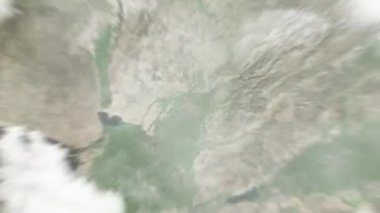 Dünya uzaydan Taşkent, Özbekistan 'a yakınlaşacak. Arkasından bulutlar ve atmosferden uzaya zum geliyor. Uydu görüntüsü. Seyahat girişi