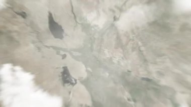 Dünya uzaydan Bağdat 'a, Irak' tan Şehit Anıtı 'na yakınlaşacak. Arkasından bulutlar ve atmosferden uzaya zum geliyor. Uydu görüntüsü. Seyahat girişi