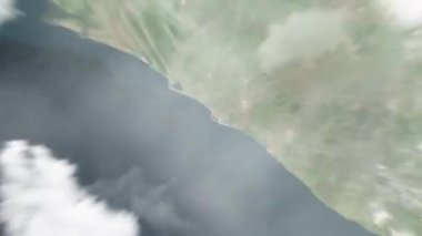 Dünya, uzaydan Monrovia, Liberya 'ya yakınlaşır. Arkasından bulutlar ve atmosferden uzaya zum geliyor. Uydu görüntüsü. Seyahat girişi
