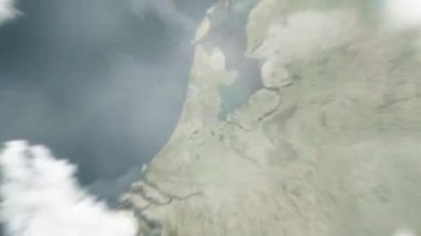 Dünya, uzaydan Amsterdam 'a, Tropenmuseum' daki Hollanda 'ya yakınlaşır. Arkasından bulutlar ve atmosferden uzaya zum geliyor. Uydu görüntüsü. Seyahat girişi