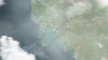 Dünya, uzaydan Bissau 'ya, Gine-Bissau' ya yakınlaş. Arkasından bulutlar ve atmosferden uzaya zum geliyor. Uydu görüntüsü. Seyahat girişi