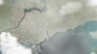 Dünya, uzaydan Melitopol 'e, Ukrayna' nın merkez meydanına yakınlaşır. Arkasından bulutlar ve atmosferden uzaya zum geliyor. Uydu görüntüsü. Seyahat girişi