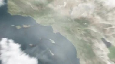 Dünya, uzaydan Lincoln Park 'taki Long Beach' e yakınlaşacak. Arkasından bulutlar ve atmosferden uzaya zum geliyor. Uydu görüntüsü. Seyahat girişi
