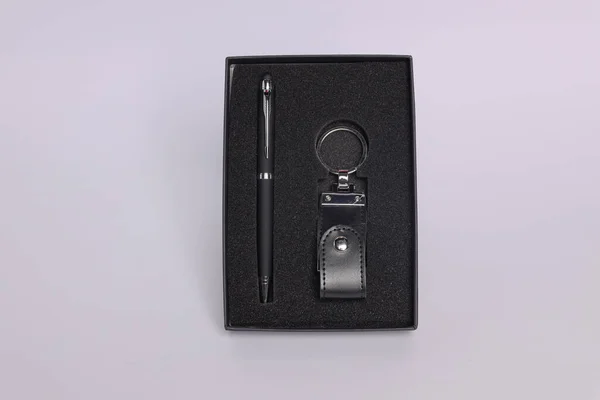 Customized corporate gift box mock up image, Personalised metal pen with mobile stylus, Customized leather keychain , Black color concept corporate gift box photography