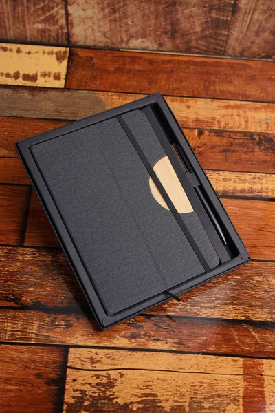 Styli\'s corporate gift box, leather note book stock image,  note book and diary isolated  wooden background  top view mockup image