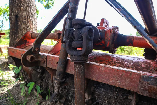 stock image Old rusty tractor in the garden. Old rusty tractor in the garden.