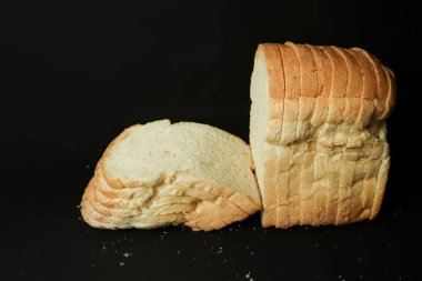 sliced bread isolated on black background, closeup of photo