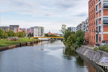 Berlin, Germany - September 23, 2022: New bridge Golda-Meir-Steg over the Berlin-Spandau shipping canal, watchtower of the Guenter Litfin Memorial at Kieler Eck and new residential quate