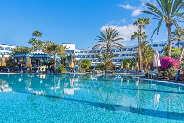 Puerto del Carmen, Spain - November 30, 2022: Pool landscape with tropical plants native to the Canary Island taken in the seaside resort of Playa de los Pocillos