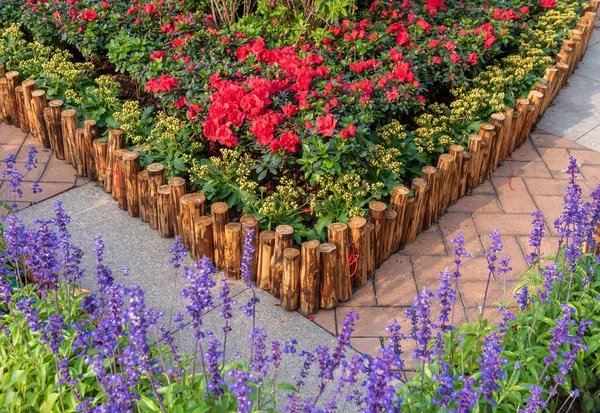 Wooden fence in beautiful backyard flower garden
