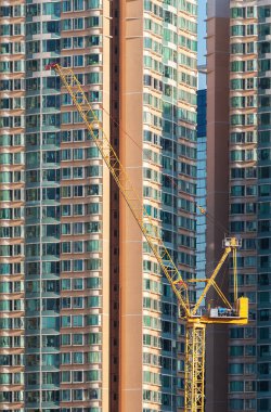 High rise residential building and crane in construction site in Hong Kong city