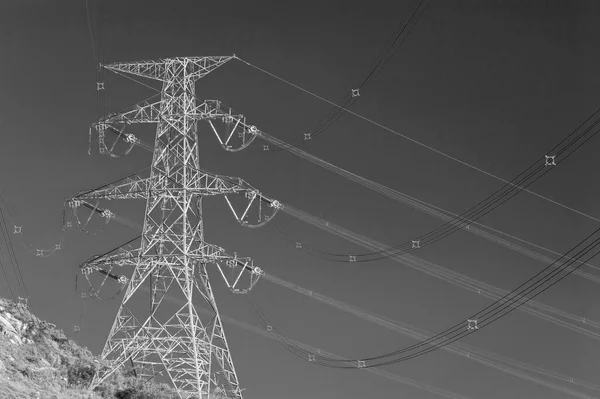 Electric pylon with electric line on hill top