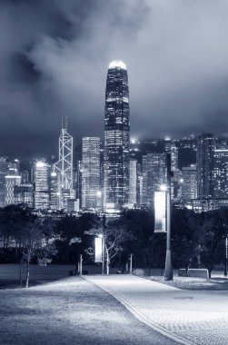 pedestrian walkway in park and skyline of Hong Kong city at night clipart