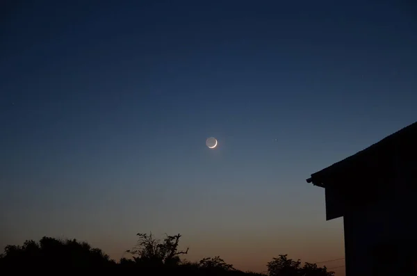 stock image part of the Moon is illuminated by a mysterious light that was historically known as 