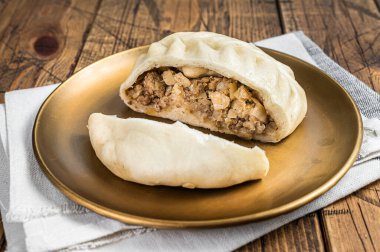 Wang Mandu Pyanse steamed pie stuffed with vegetable and meat Wooden background. Top view.