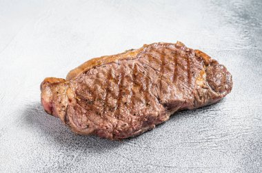 Grilled New York striploin beef meat steak. White background. Top view.