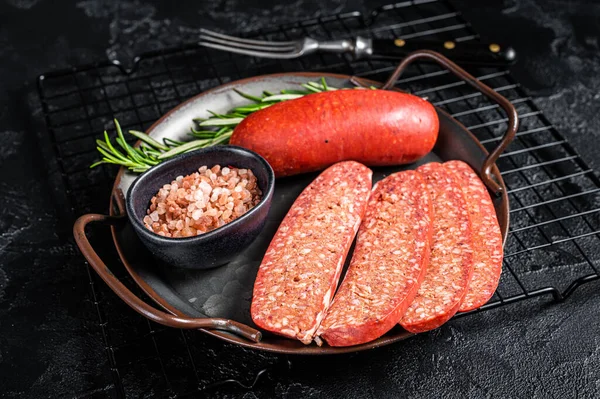 stock image Turkish Sliced Sucuk beef meat sausage ready for cooking. Black background. Top view.