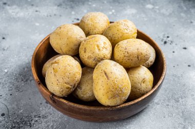 Canarian boiled potatoes papas arrugadas. Gray background. Top view.