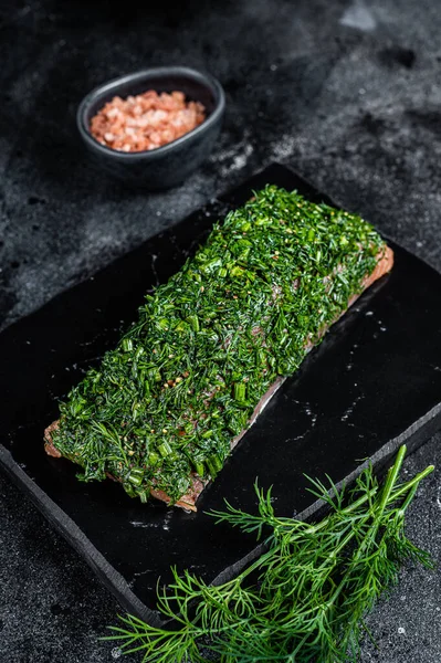 Nordic Gravlax Salmon fillet with dill. Black background. Top view.