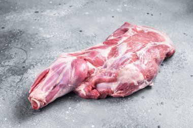 Raw lamb shoulder meat on butcher table. Gray background. Top view.