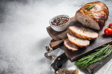 Sliced Rolled meatloaf, ground meat loaf with bacon. White background. Top view. Copy space.