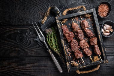 BBQ Beef veal shish kebab Skewers. Black background. Top view. Copy space.