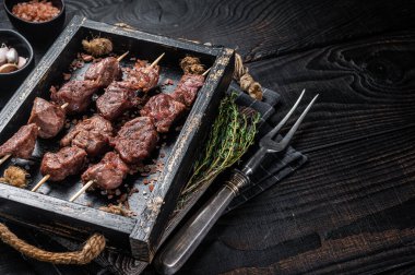 BBQ Beef veal shish kebab Skewers. Black background. Top view. Copy space.