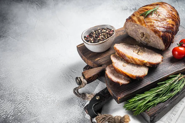 Sliced Rolled meatloaf, ground meat loaf with bacon. White background. Top view. Copy space.