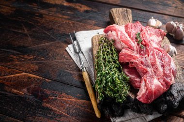 Çiğ kemiksiz kuzu eti, tahta tahtada çiğ boyun eti. Siyah arka plan. Üst Manzara. Boşluğu kopyala.