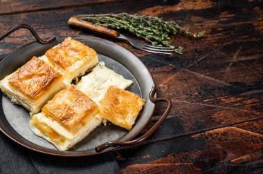 Turkish Su Boregi, Tabla borek or Adana Borek with cheese. Wooden background. Top view. Copy space.