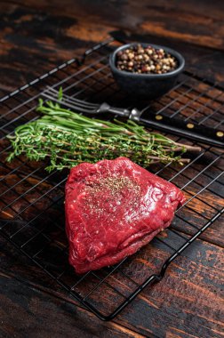 Rump steak with spices, raw beef meat. Wooden background. Top view.
