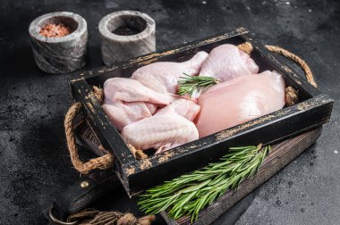 Taze çiğ tavuk eti ve tavuk parçaları - but, göğüs filetosu, kanat, but. Siyah arka plan. Üst görünüm.