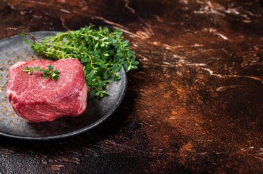 Prime Fillet Mignon Beef steak, Dry aged raw tenderloin meat. Dark background. Top view. Space for text.
