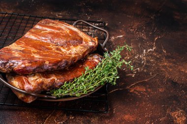 Smoked Barbecue Pork Ribs, Sparerib in kitchen tray. Dark background. Top view. Copy space.