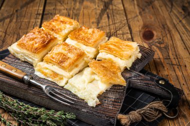 Delicious Turkish Tray pastry, Su boregi with cheese. Wooden background. Top view.