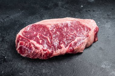 Raw Striploin steak, beef butchery cut. Black background. Top view.